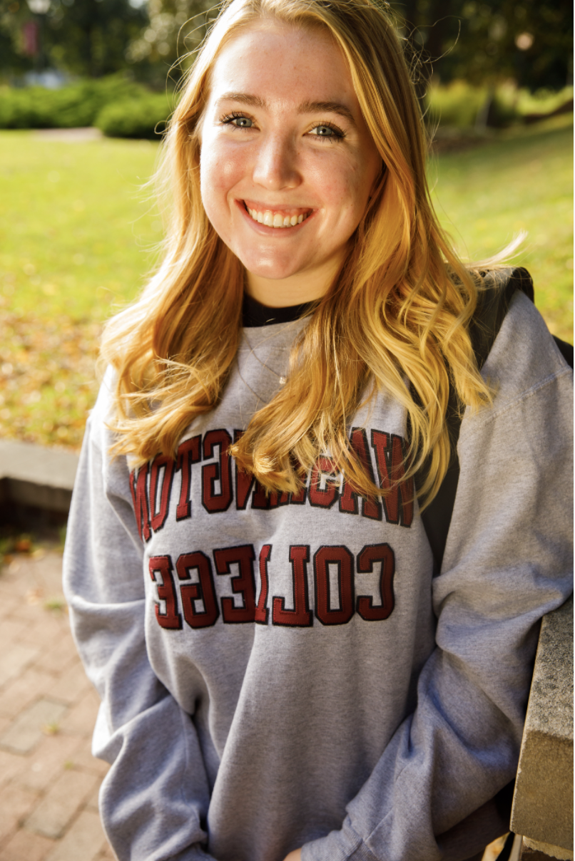 Haley, smiling 和 wearing a grey hoodie with 